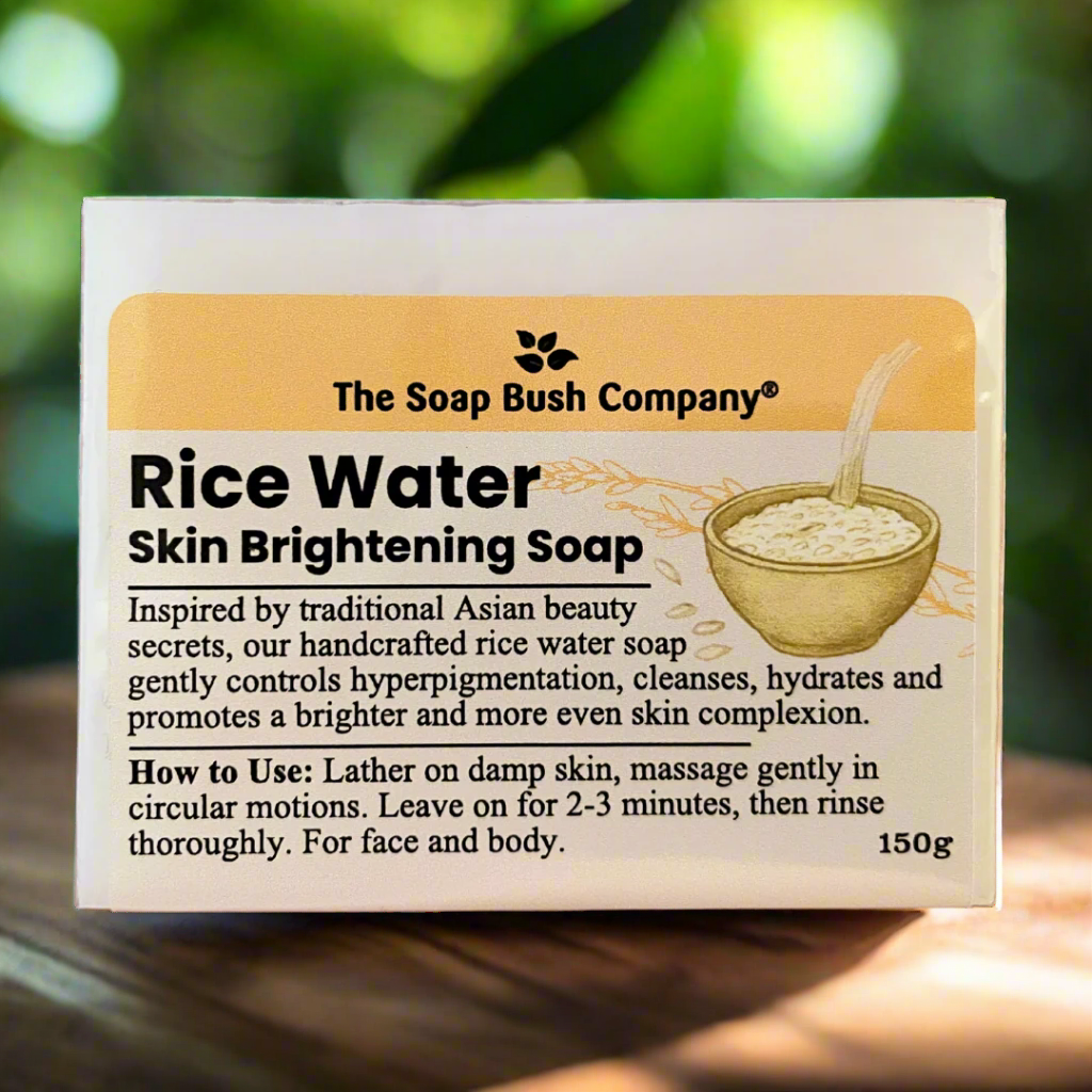 Box of Rice Water Skin Brightening Soap from The Soap Bush Company with a blurred green background, made from formented rice water, the soap bush company rice water soap bar